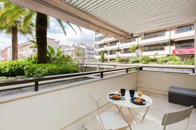 a table and chairs on the balcony of a building at Gray d'Albion YourHostHelper in Cannes