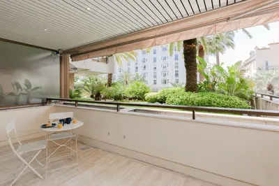 a view from the balcony of a building with a table at Gray d'Albion YourHostHelper in Cannes