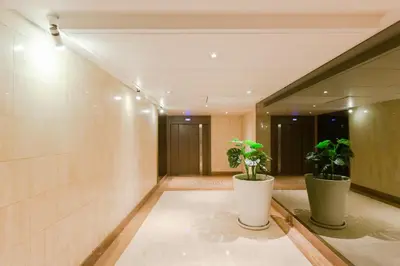 a hallway with two potted plants in a building at Gray d'Albion YourHostHelper in Cannes