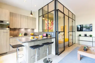 a kitchen with a counter and some stools in it at Gray d'Albion YourHostHelper in Cannes