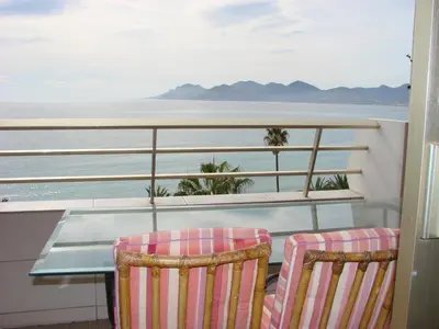 a balcony with two chairs and a table on a ship at Cannes Sea View in Cannes