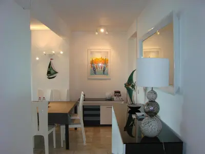 a kitchen and dining room with a table and a dining room at Cannes Sea View in Cannes