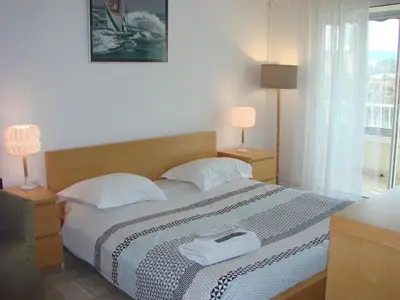 a bedroom with a bed and two lamps and a window at Cannes Sea View in Cannes
