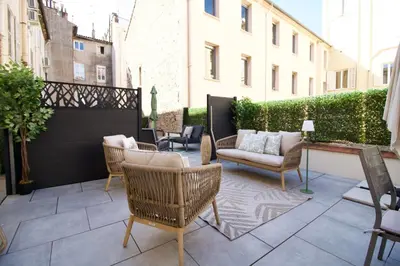 a patio with wicker chairs and a couch at Cannes Spacious 4 Bedroom Apartment with Sunny Terrace in Cannes