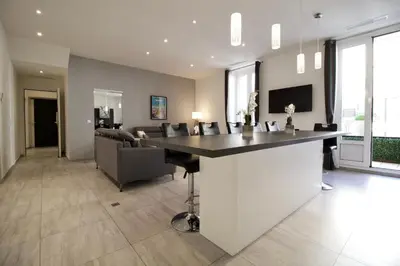 a kitchen and living room with a bar and a couch at Cannes Spacious 4 Bedroom Apartment with Sunny Terrace in Cannes