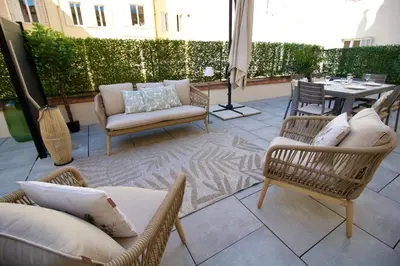 a patio with chairs and a table and a table and chairs at Cannes Spacious 4 Bedroom Apartment with Sunny Terrace in Cannes
