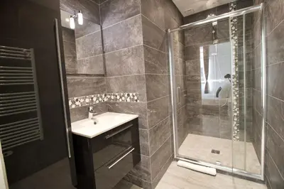 a bathroom with a shower and a sink and a glass shower stall at Cannes Spacious 4 Bedroom Apartment with Sunny Terrace in Cannes