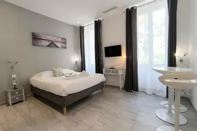 a bedroom with a bed and a sink in it at Cannes Spacious 4 Bedroom Apartment with Sunny Terrace in Cannes
