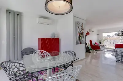a dining room with a glass table and chairs at IMMOGROOM - Apartment with terrace - AC - Parking in Cannes