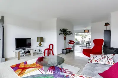 a living room with red chairs and a glass table at IMMOGROOM - Apartment with terrace - AC - Parking in Cannes