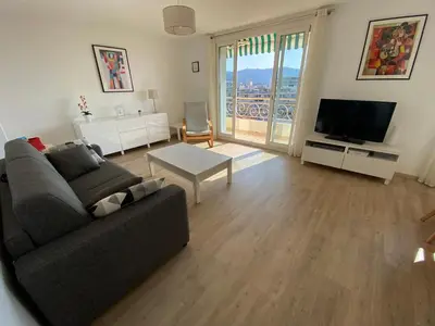 a living room with a couch and a television at VUE MER - Appartement T2 in Cannes