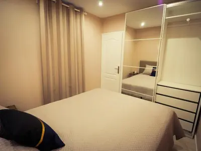a small bedroom with a bed and a mirror at Delaup Sea Cannes in Cannes