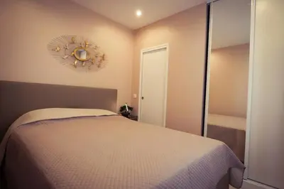 a bedroom with a bed and a clock on the wall at Delaup Sea Cannes in Cannes