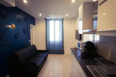 a living room with a couch and a kitchen at Delaup Sea Cannes in Cannes