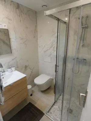 a bathroom with a shower and a toilet and a sink at Delaup Sea Cannes in Cannes