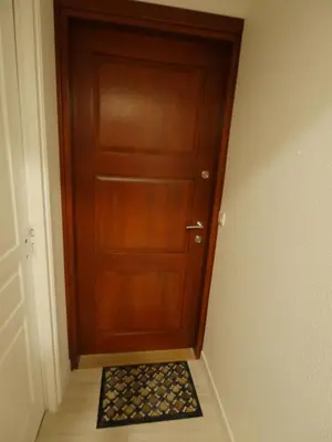 a wooden door with a door mat in front of it at Delaup Sea Cannes in Cannes