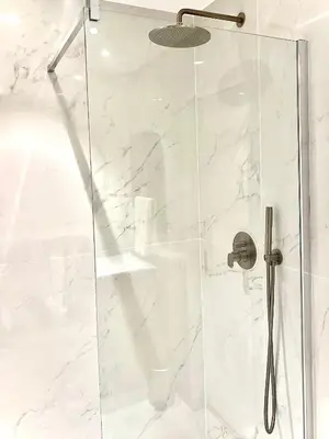 a glass shower door with a toilet in a bathroom at Grand 2 pieces Gray d'Albion in Cannes