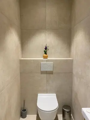 a bathroom with a white toilet and a sink at Grand 2 pieces Gray d'Albion in Cannes