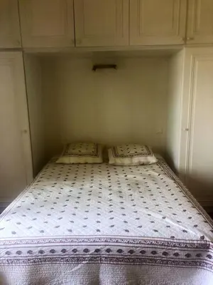 a bed in a room with two pillows on it at Appartement moderne à Cannes avec vue sur mer et montagne - 85 m² in Cannes