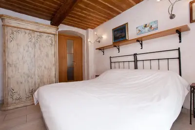 a bedroom with a white bed and a wooden ceiling at Frères Suquet Sea Cannes in Cannes