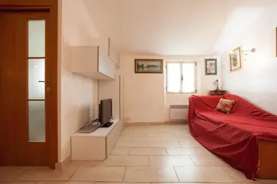 a living room with a red couch and a television at Frères Suquet Sea Cannes in Cannes