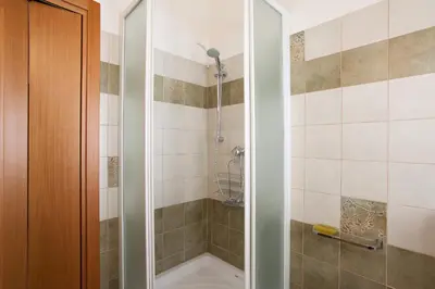 a bathroom with a shower with a tub at Frères Suquet Sea Cannes in Cannes