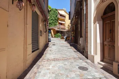 an empty alley in a city with buildings at Frères Suquet Sea Cannes in Cannes