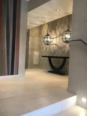 a room with two lights on the wall and a table at Eve in Cannes