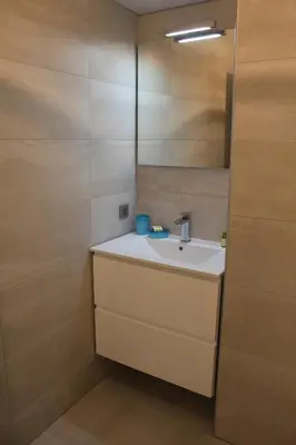 a bathroom with a white sink and a mirror at Eve in Cannes