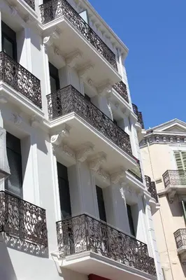 a white building with balconies on it at Eve in Cannes