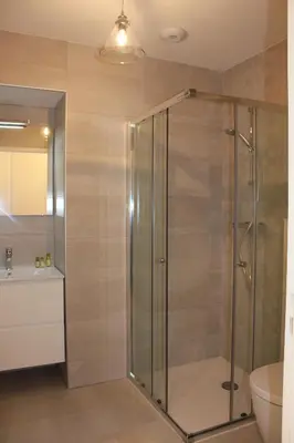 a bathroom with a shower with a toilet and a sink at Eve in Cannes