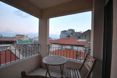 a balcony with a table and chairs and a view at Le Vieux Port Apartments in Cannes