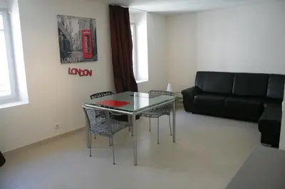 a living room with a glass table and a couch at Le Vieux Port Apartments in Cannes