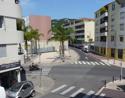 an empty street in a city with cars and buildings at Lovely Studio Cannes in Cannes