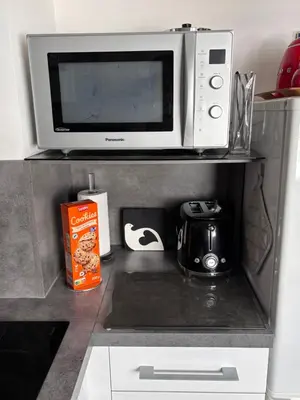 a microwave oven sitting on top of a kitchen counter at Lovely Studio Cannes in Cannes