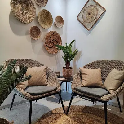 two chairs and a table with a plant on a wall at Cristal Hôtel & Spa in Cannes