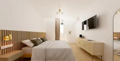 a bedroom with a bed with a mirror and a tv at Hotel le Romanesque in Cannes