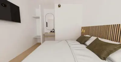 a bedroom with a large white bed and a television at Hotel le Romanesque in Cannes