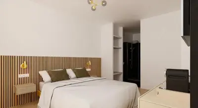 a white bedroom with a bed and a television at Hotel le Romanesque in Cannes