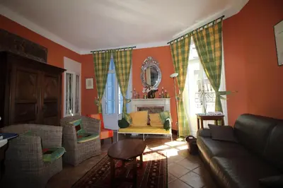 a living room with orange walls and a couch and chairs at AGENCIA appartement Rue d'Antibes in Cannes