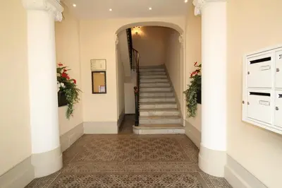 a hallway with a staircase with white columns at AGENCIA appartement Rue d'Antibes in Cannes