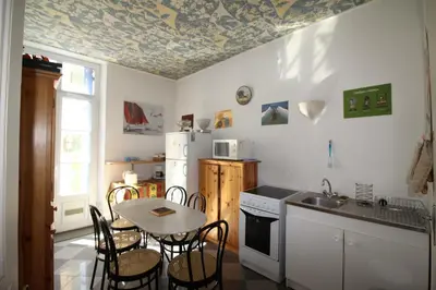 a kitchen with a table and chairs and a refrigerator at AGENCIA appartement Rue d'Antibes in Cannes