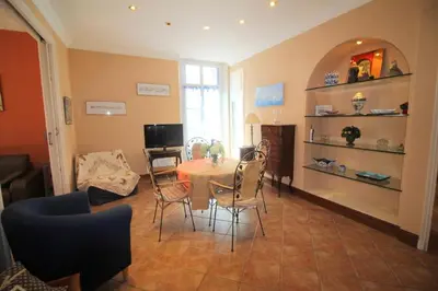 a living room with a table and chairs at AGENCIA appartement Rue d'Antibes in Cannes