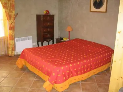 a bedroom with a red bed and a dresser at AGENCIA appartement Rue d'Antibes in Cannes
