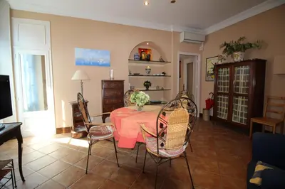 a dining room with a table and chairs at AGENCIA appartement Rue d'Antibes in Cannes