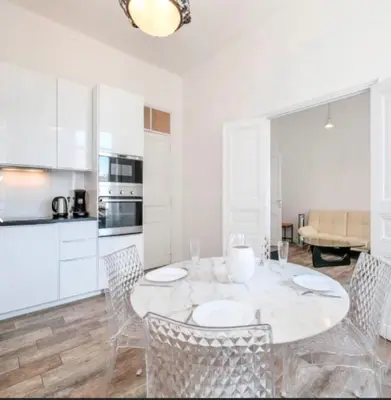a white dining room with a table and chairs at Ice coeur de Cannes in Cannes