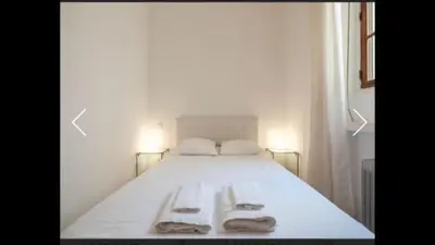 a white bed with two towels on top of it at Ice coeur de Cannes in Cannes