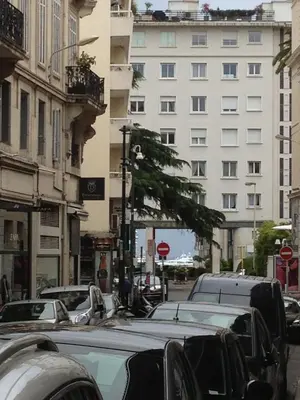 a city street filled with parked cars and buildings at Ice coeur de Cannes in Cannes