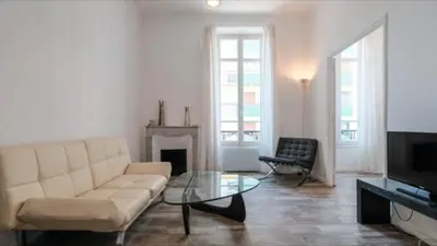 a living room with a couch and a fireplace at Ice coeur de Cannes in Cannes