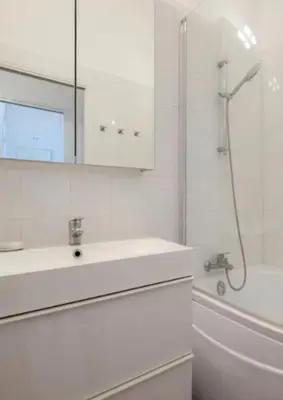 a white bathroom with a sink and a tub at Ice coeur de Cannes in Cannes